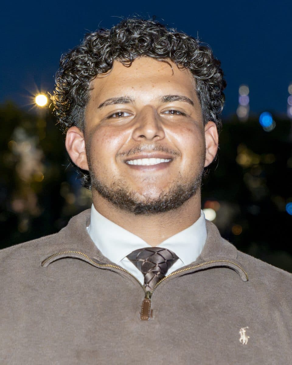 Abanoub Gerges, founder and owner of Cumberland Clean Co, smiling outdoors at dusk